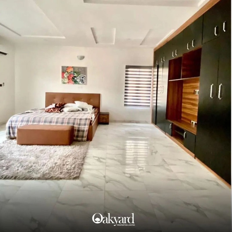 Master bedroom with fitted wardrobes and marble-effect floor tiling