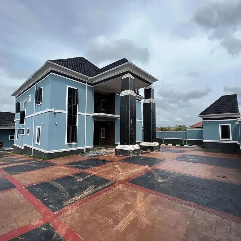 A finished two-storey home with a tiled forecourt and boys' quarters